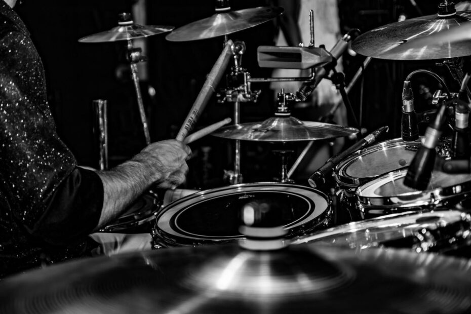 Jazzdrummer speelt op een drumstel met ridebekkens en microfoons